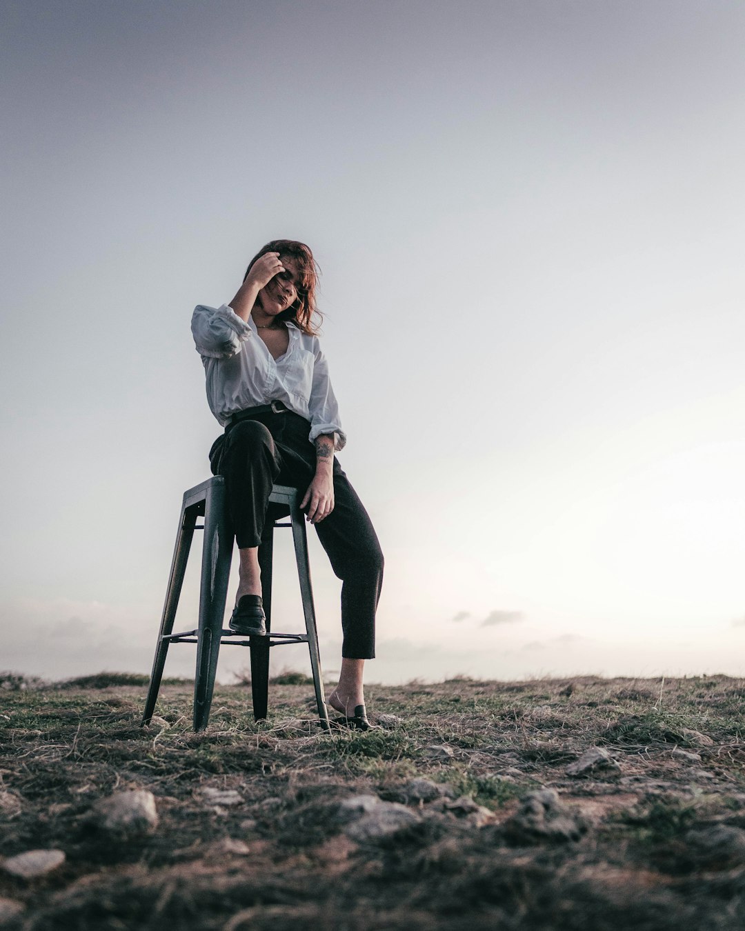 woman in white long sleeve shirt sitting on black seat