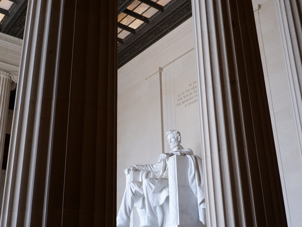 white statue of man in white robe