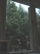 Close-up of hands wiping a desk with a green microfiber cloth surrounded by earth-toned decor.