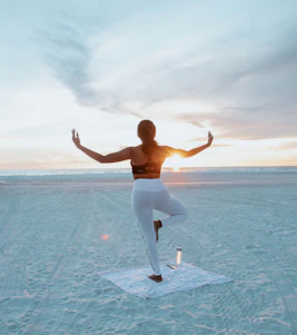 A serene yoga session at sunrise on a beach in Canggu, Bali.