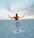 A serene yoga class on a beach at sunset.