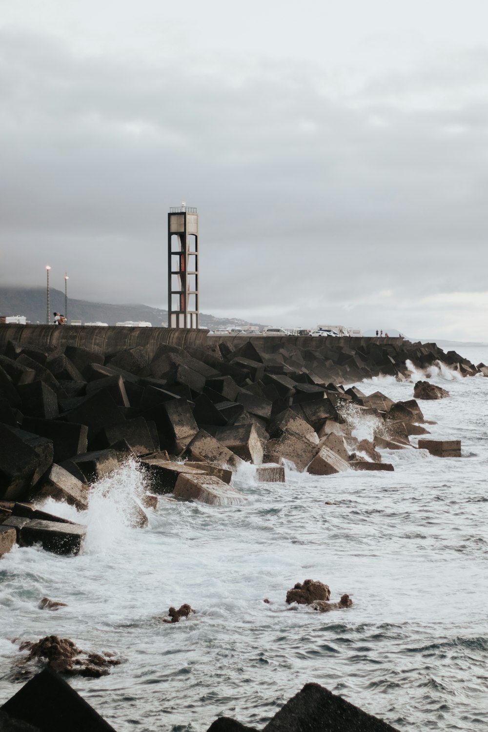 a large body of water next to a rocky shore