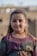 girl in blue and green crew neck shirt smiling