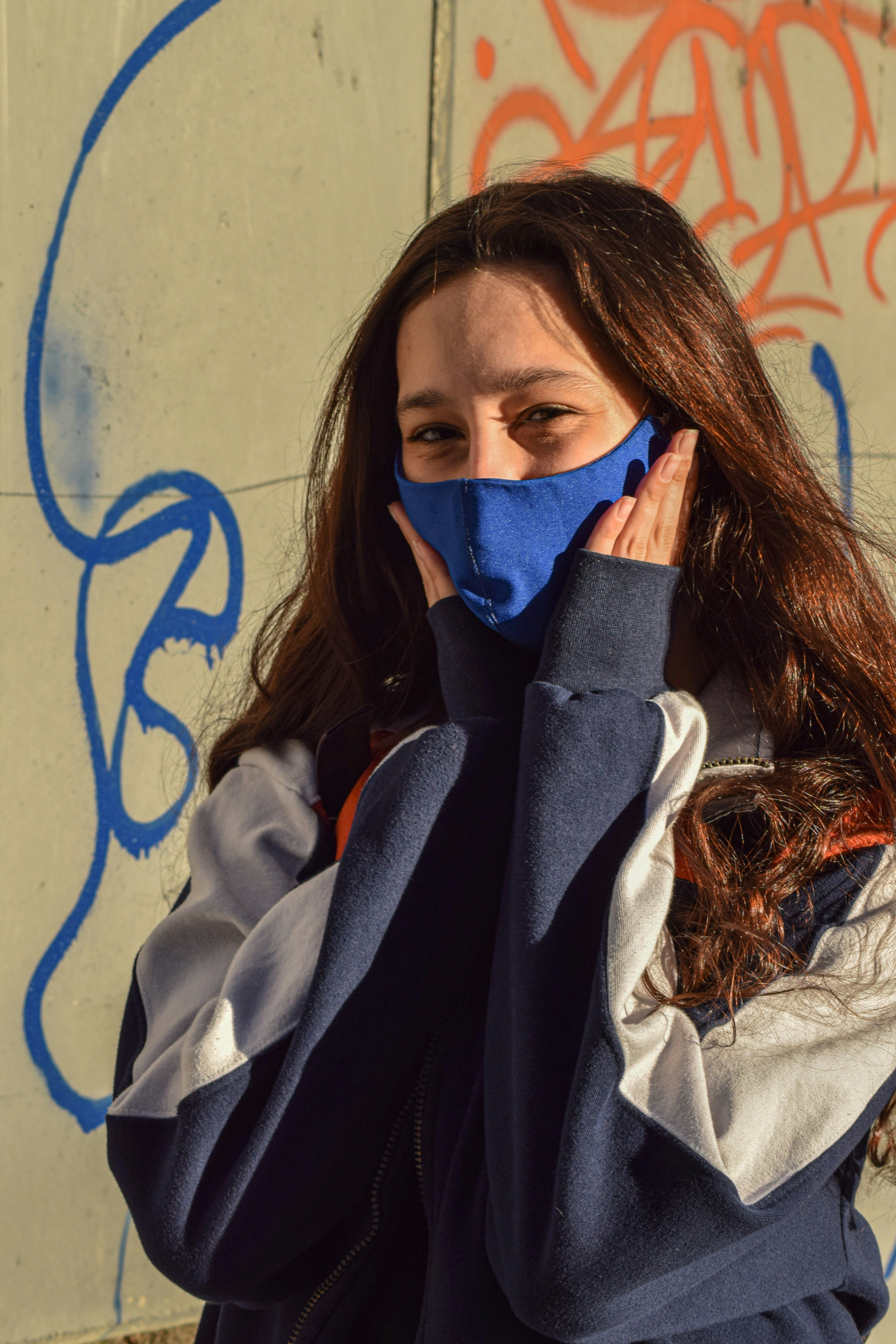 woman covering her face with blue textile