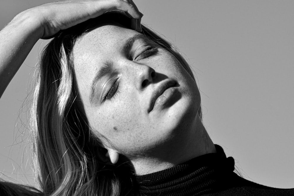 grayscale photo of woman in black turtleneck shirt