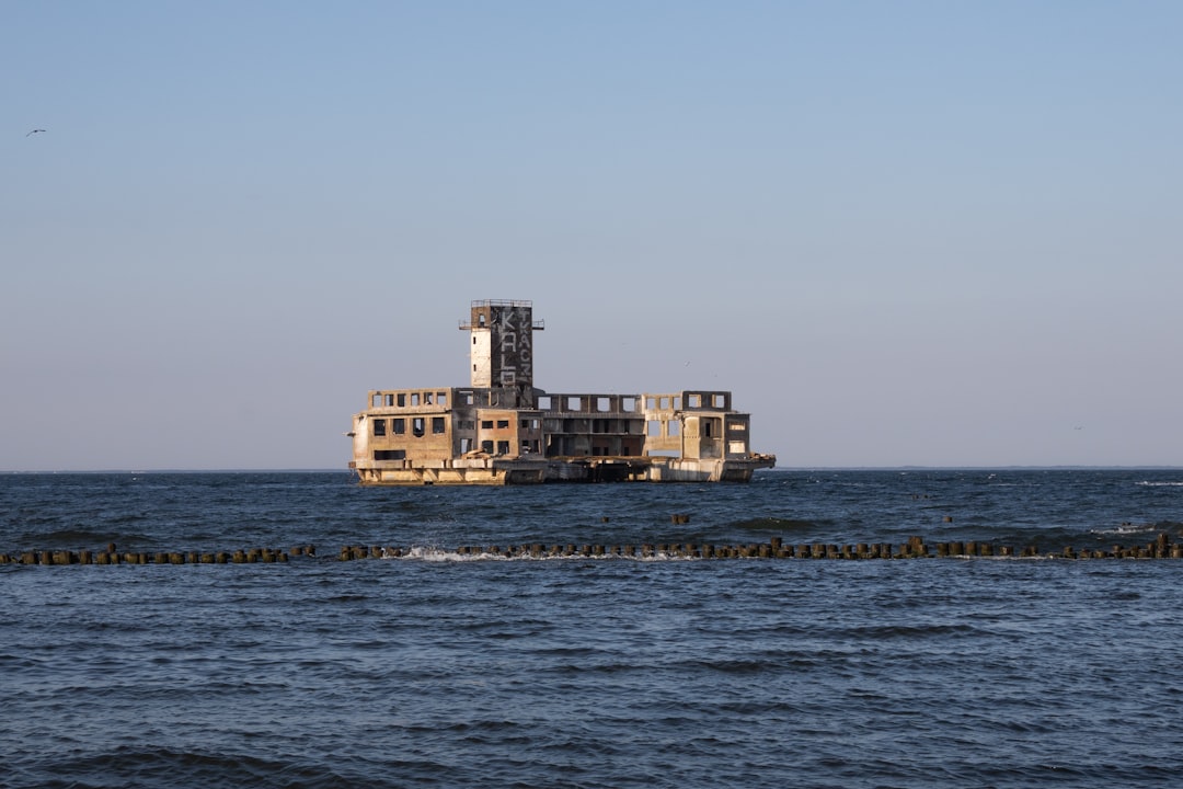 white and brown concrete building near sea during daytime