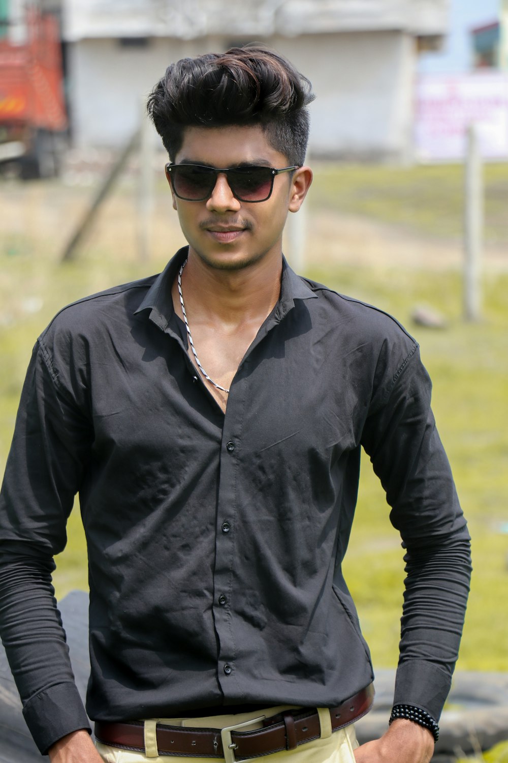 man in black dress shirt wearing black sunglasses