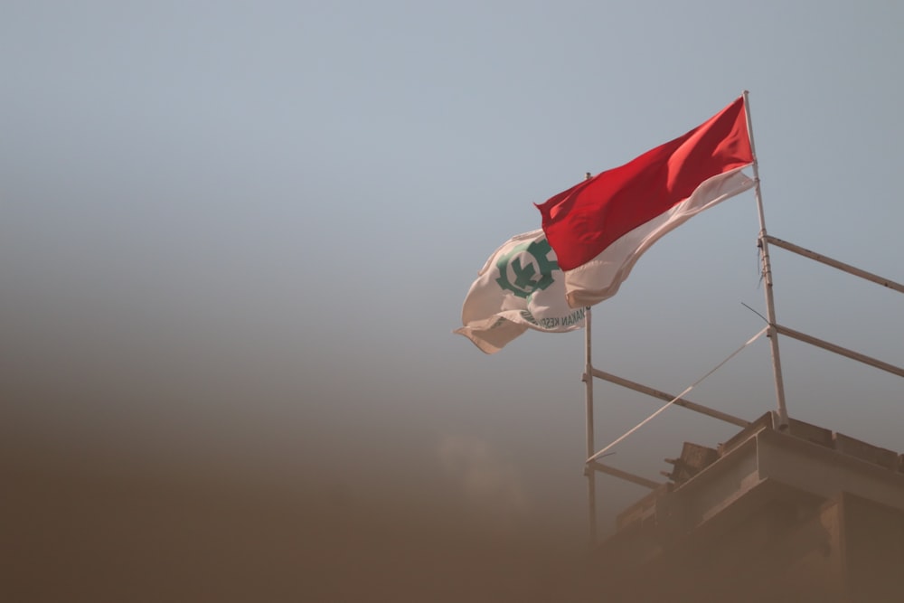 red white and green flag on pole during daytime