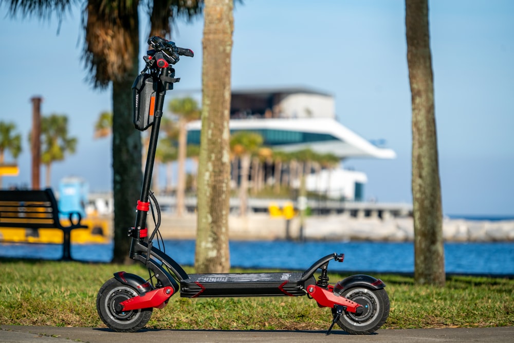 red and black bicycle with training wheels