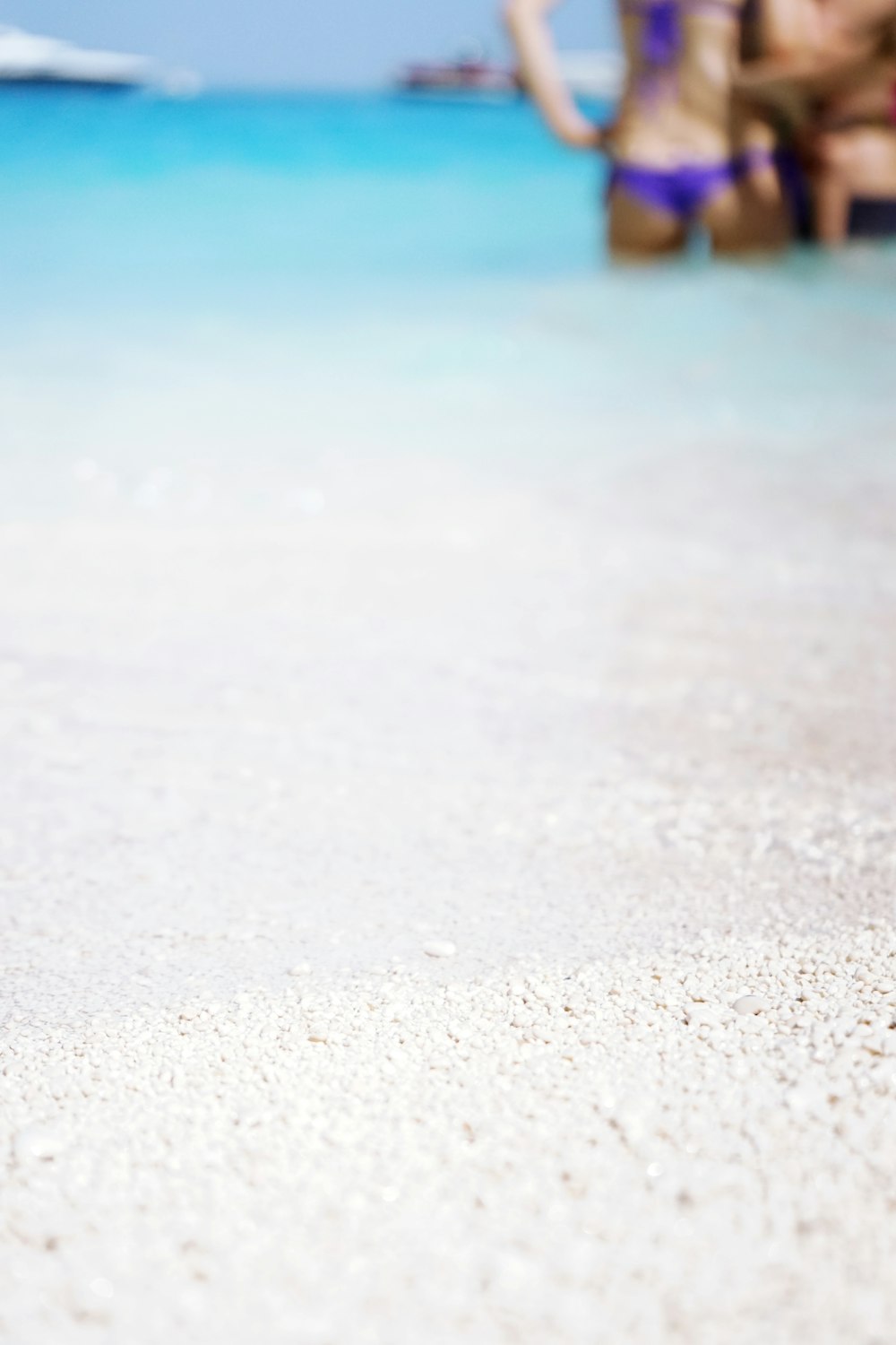 brown wooden dock on white sand during daytime