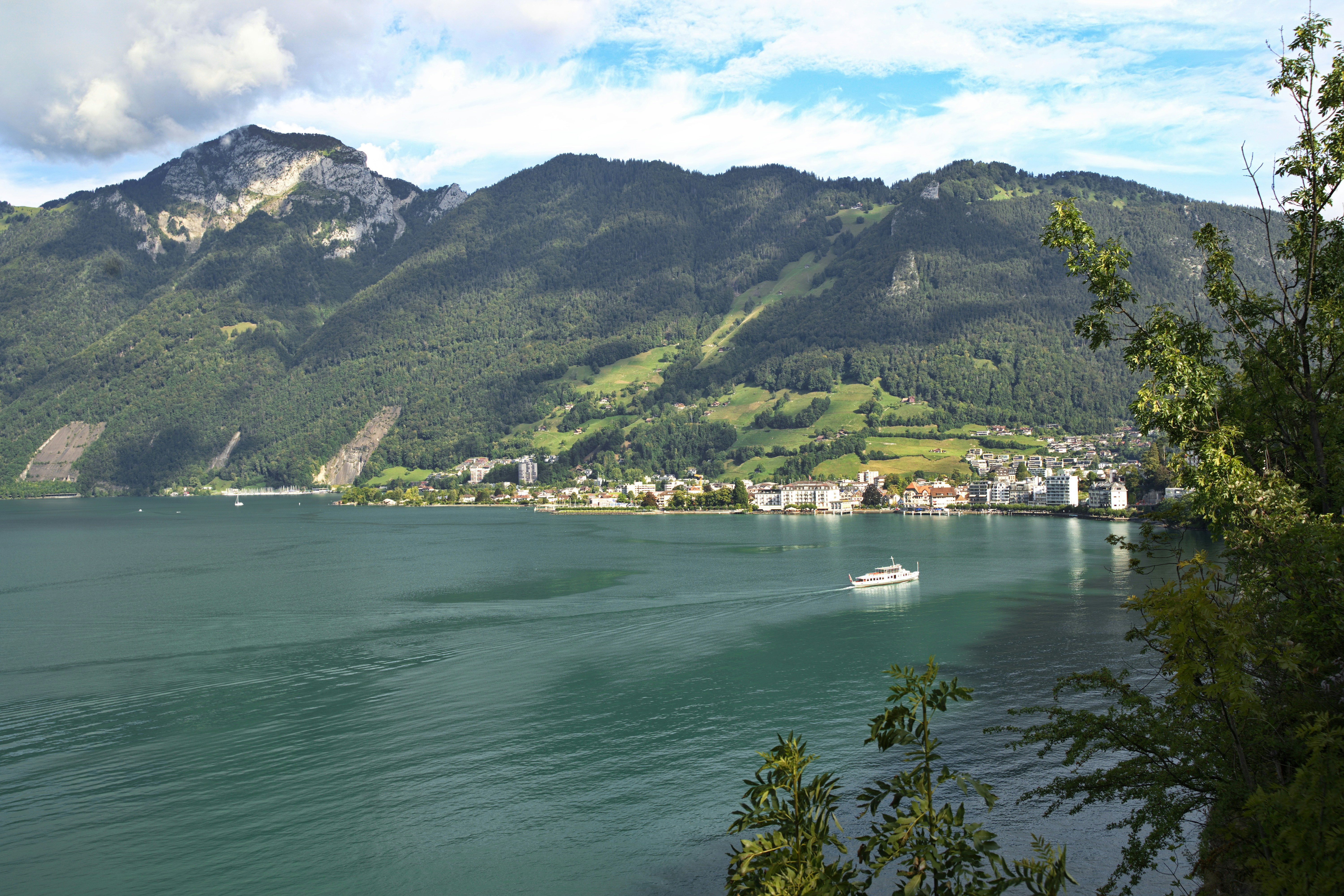 green mountains beside body of water during daytime