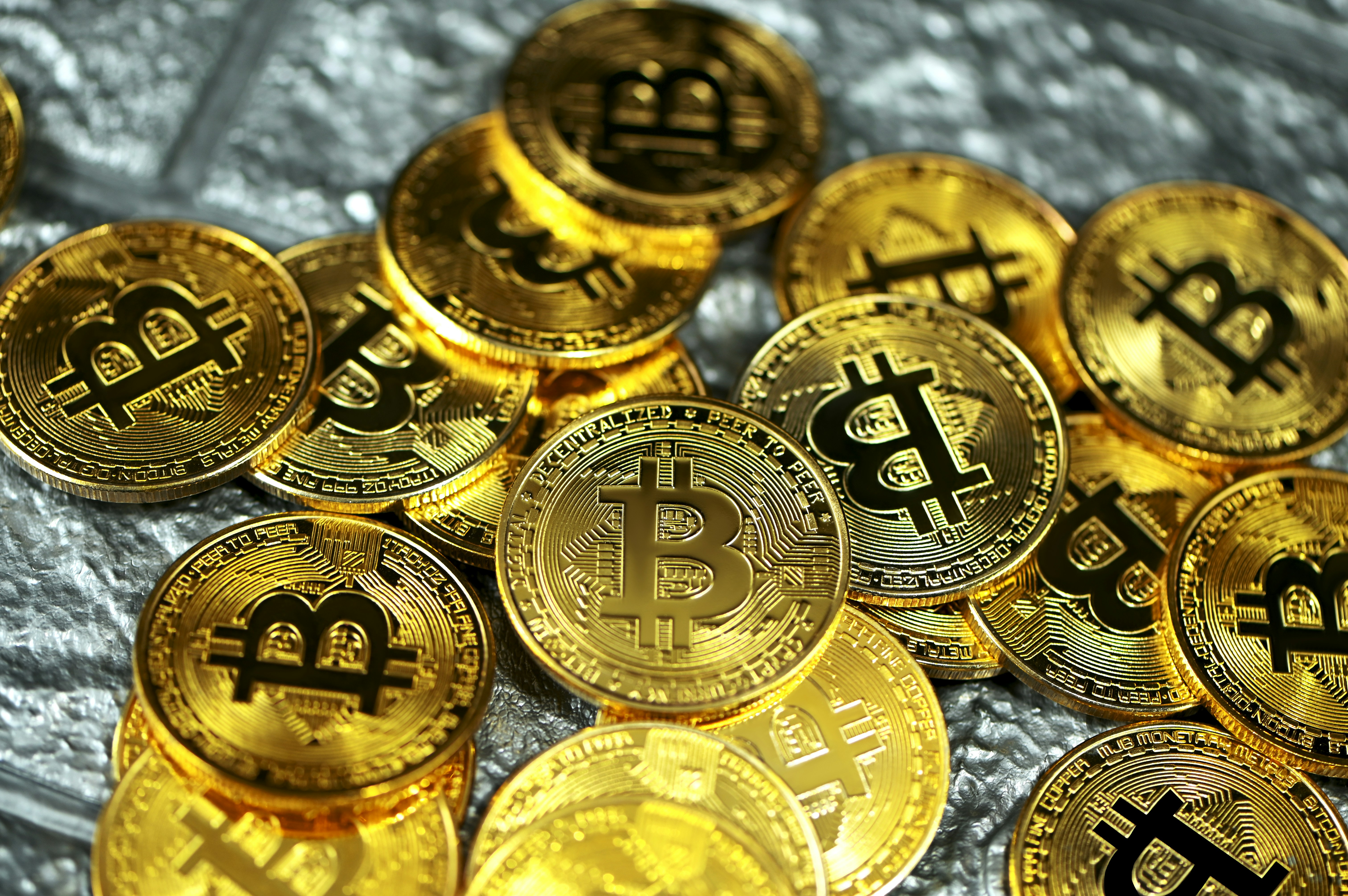 A variety of Bitcoins on top of a silver background