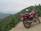 Motorcycle parked on a mountain trail with expansive forest views