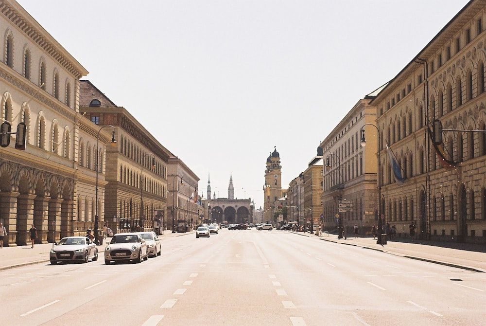 cars parked on side of the road near brown concrete building during daytime