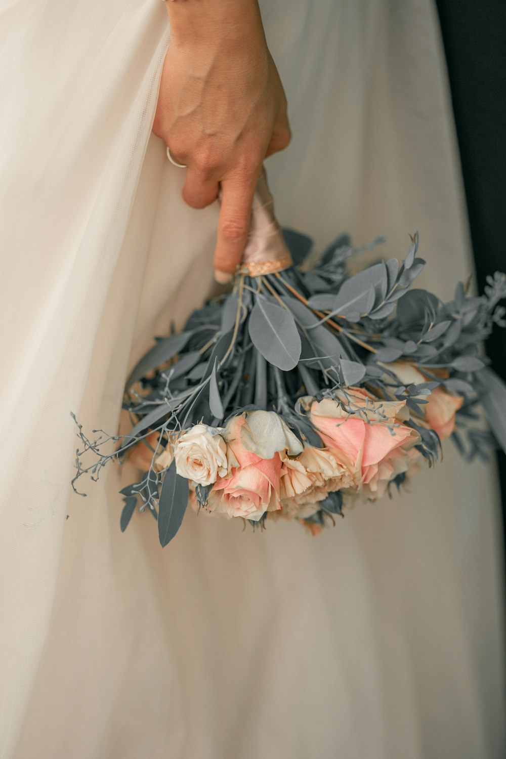 person holding white and pink flower bouquet