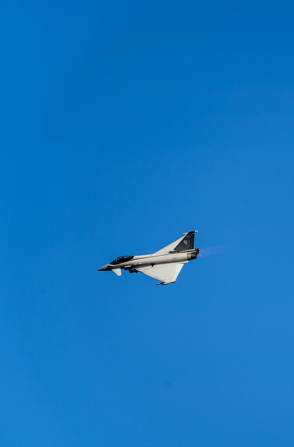 white and black airplane in mid air during daytime