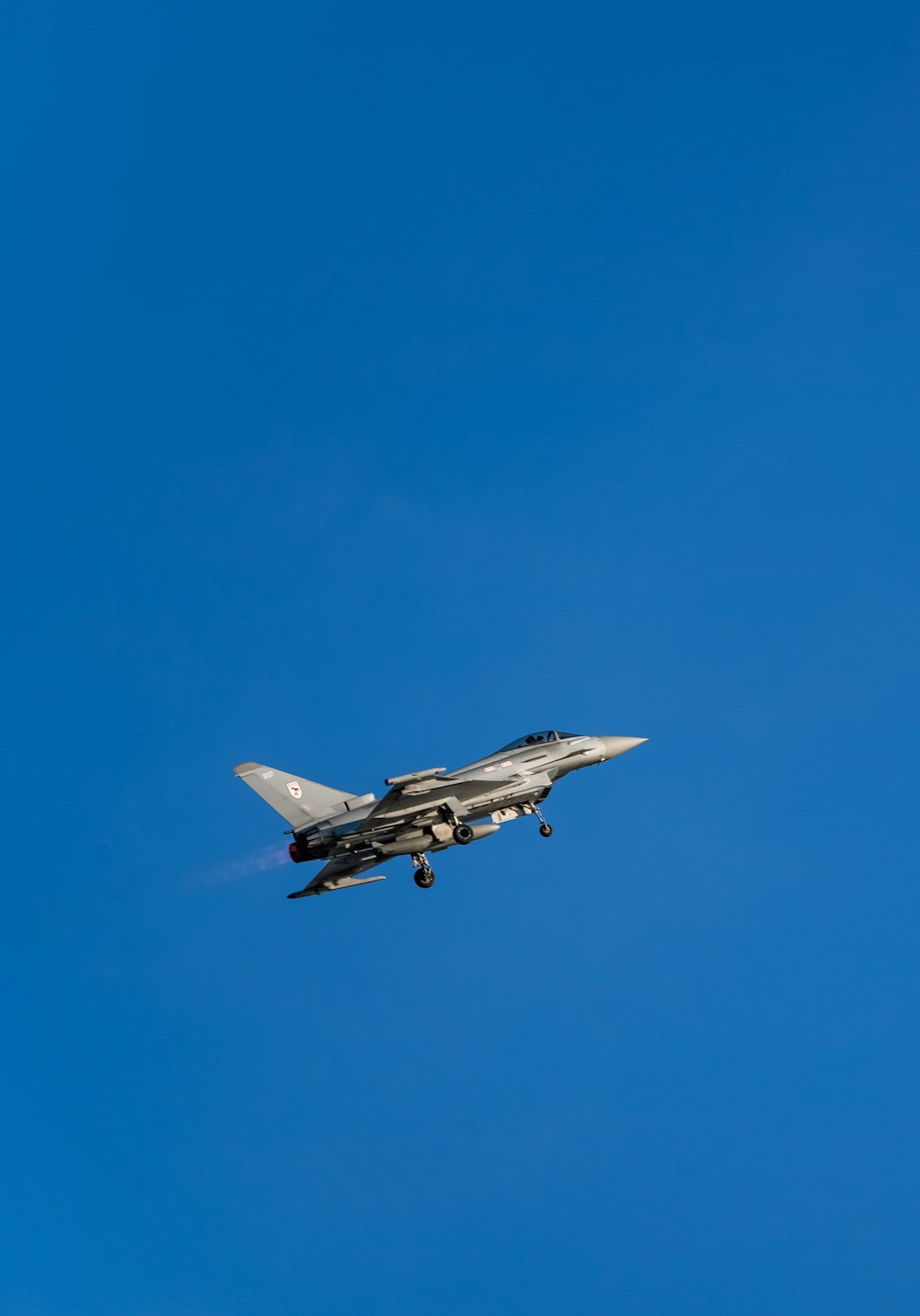 white and black jet plane in mid air during daytime