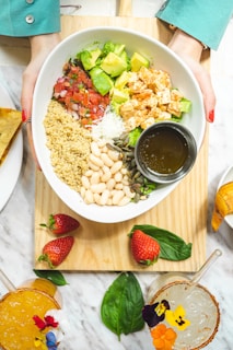 sliced strawberries and white ceramic bowl