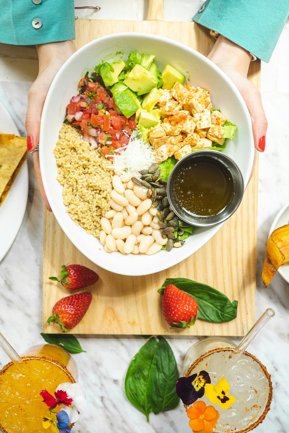 sliced strawberries and white ceramic bowl