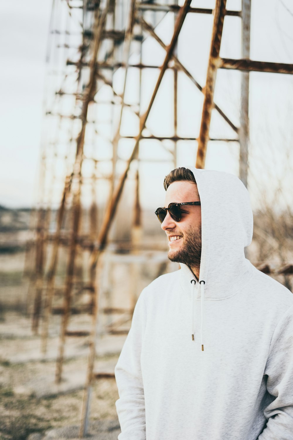 man in white hoodie wearing black sunglasses