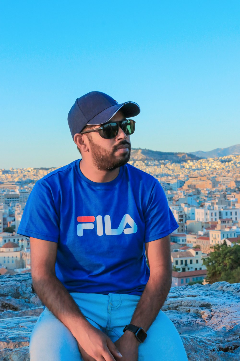 man in blue and white crew neck t-shirt and black sunglasses