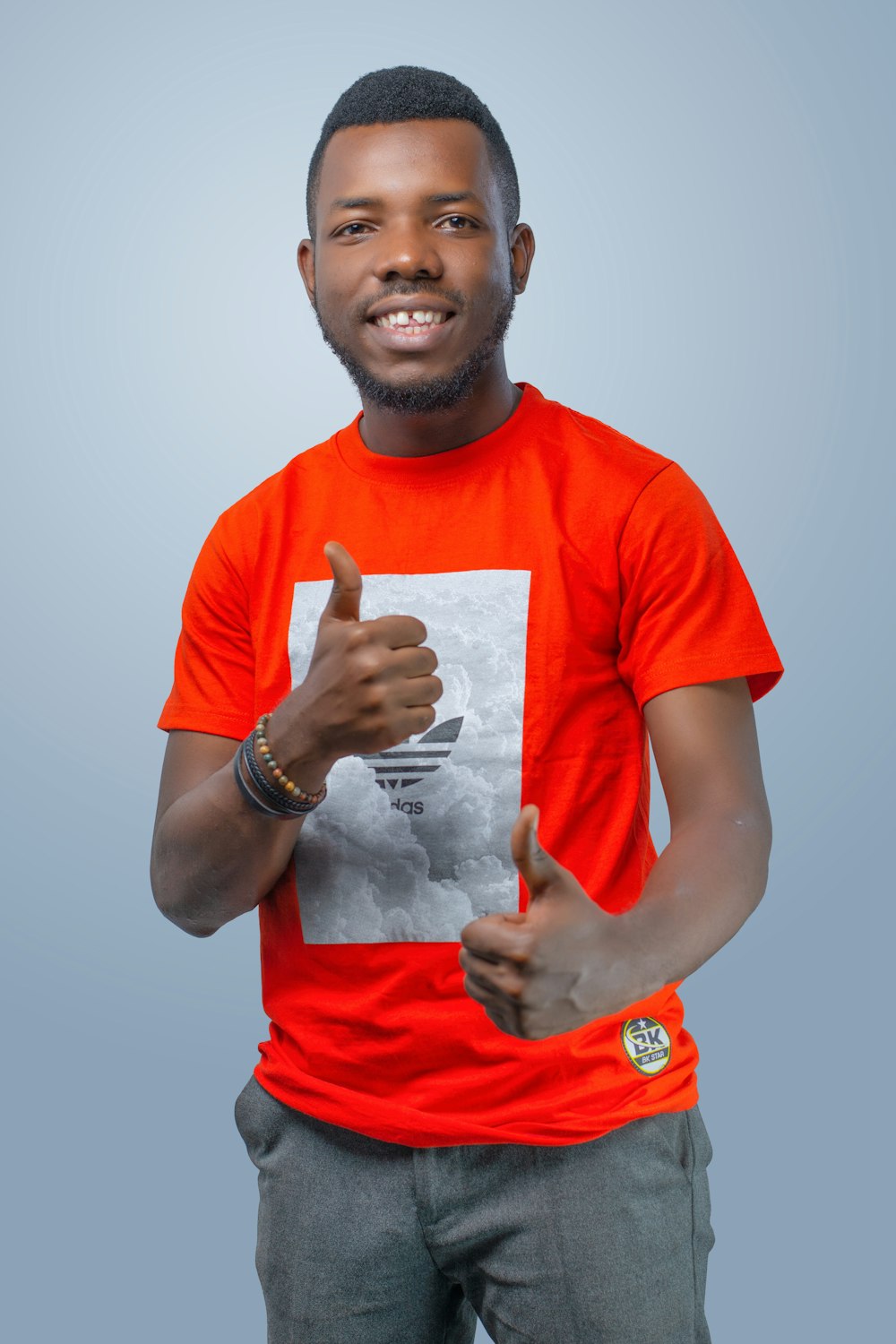 man in red crew neck t-shirt holding white cotton