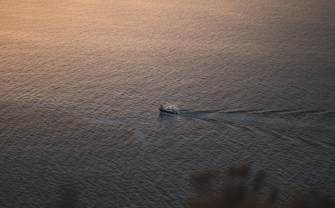 white boat on body of water during daytime