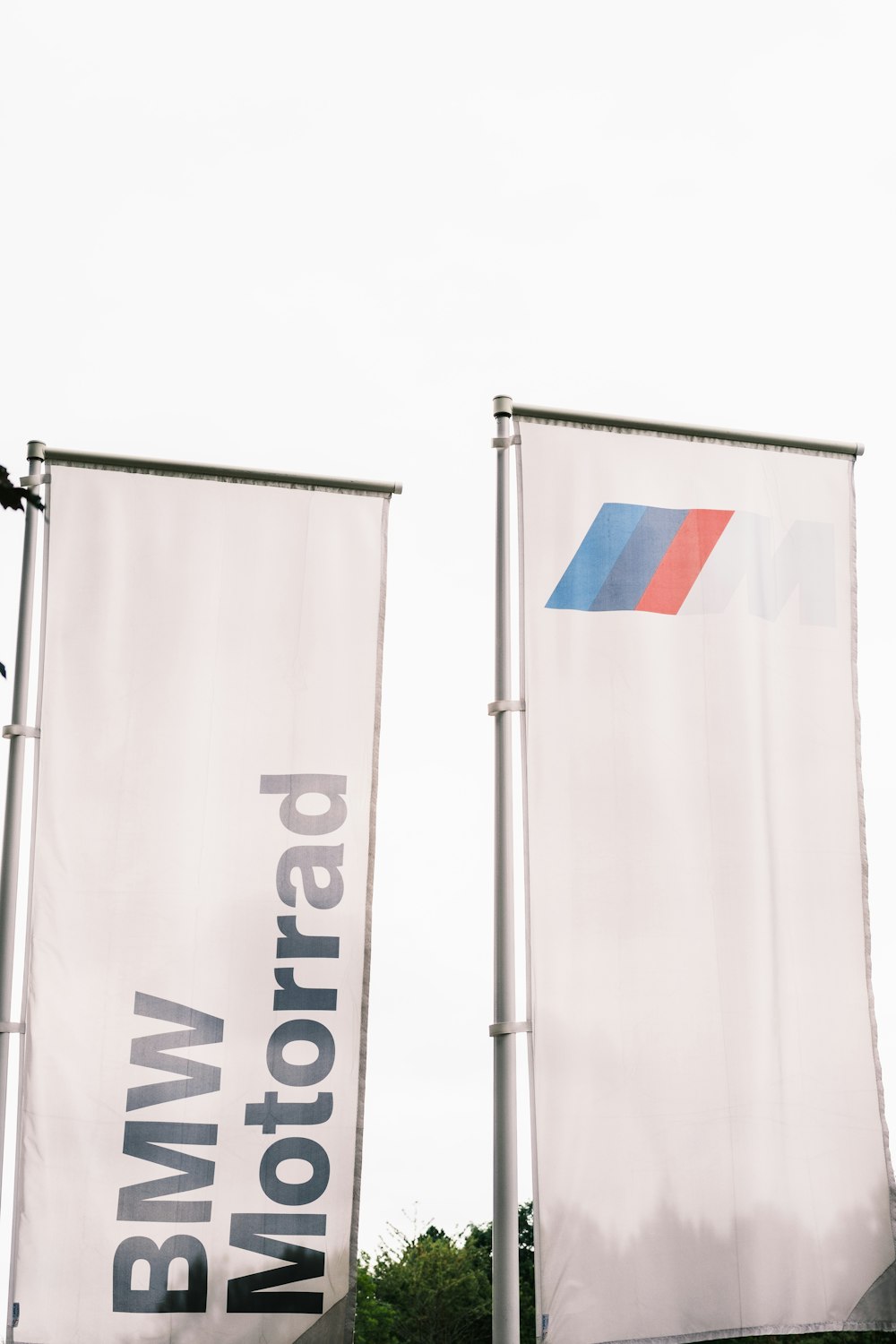 two large white banners with a bmw logo on them