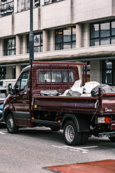 man in white shirt sitting on red truck