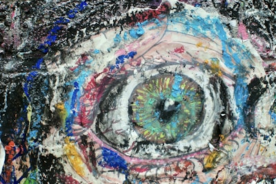 A vivid portrait featuring expressive eyes awash in electric greens and purples.