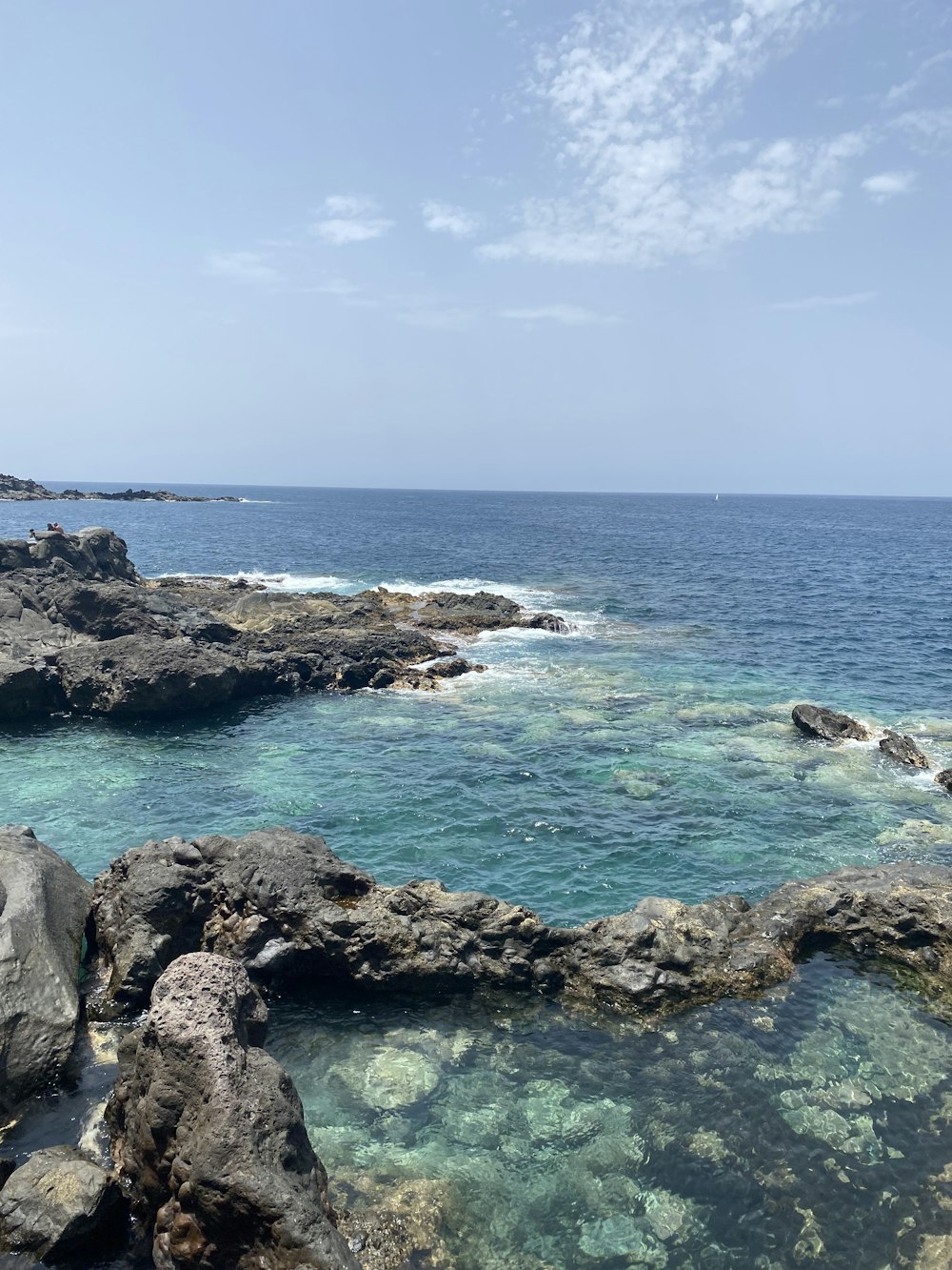 rocky shore under blue sky during daytime