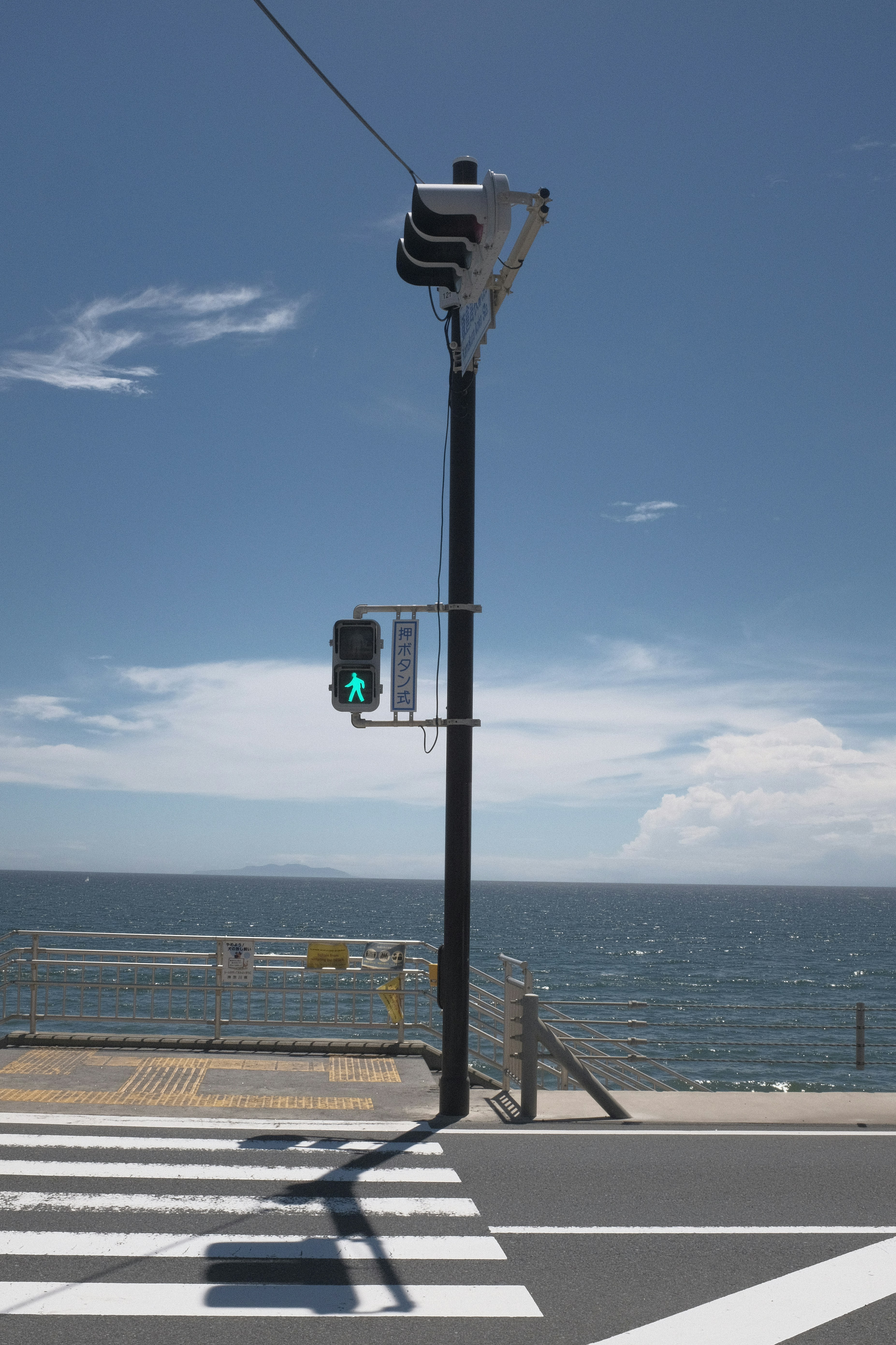 black traffic light on the beach during daytime