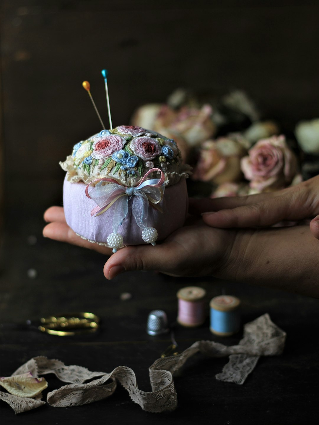 person holding white and green floral ceramic cup with white and pink powder