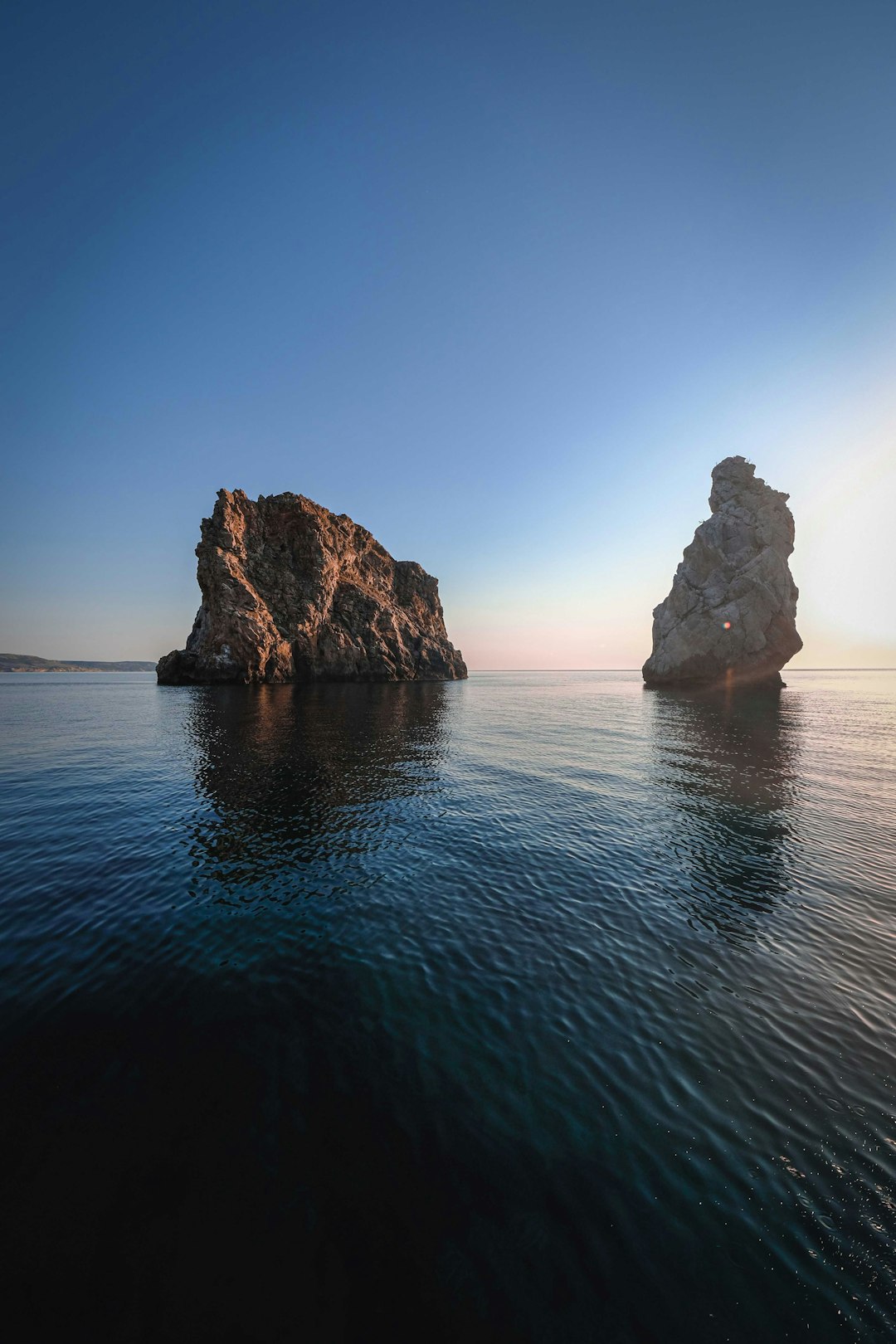 brown rock formation on sea during daytime