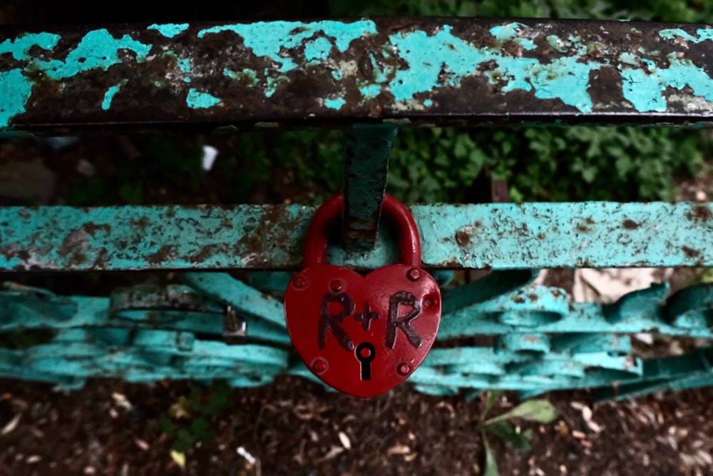 brown padlock on black metal fence