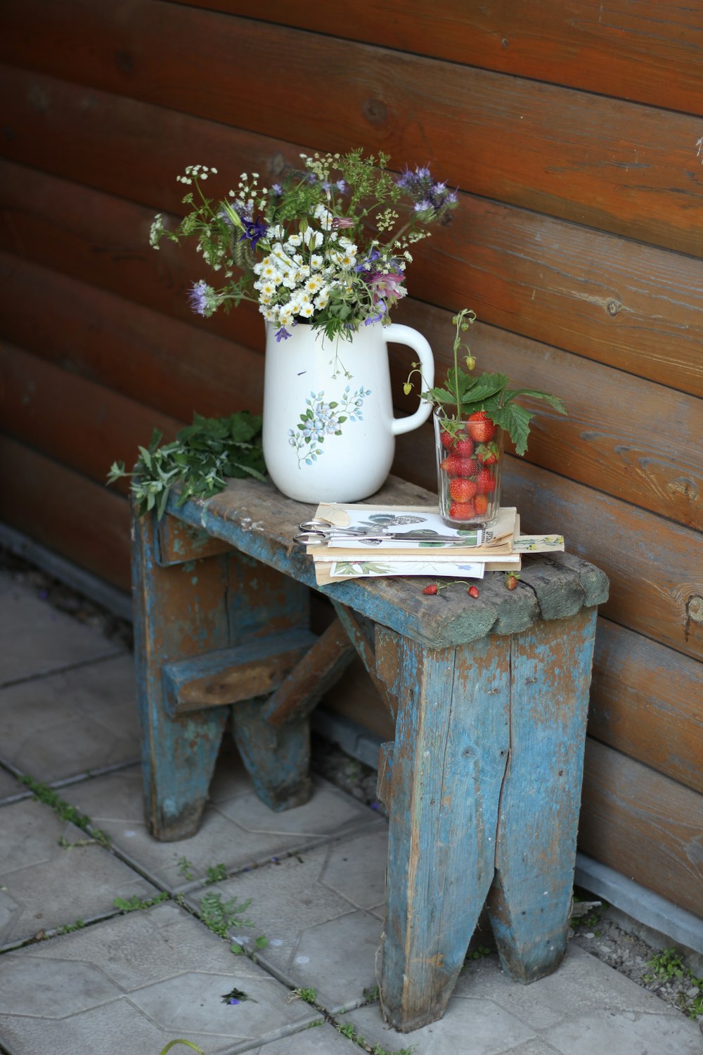 white ceramic vase with green plant on brown wooden table