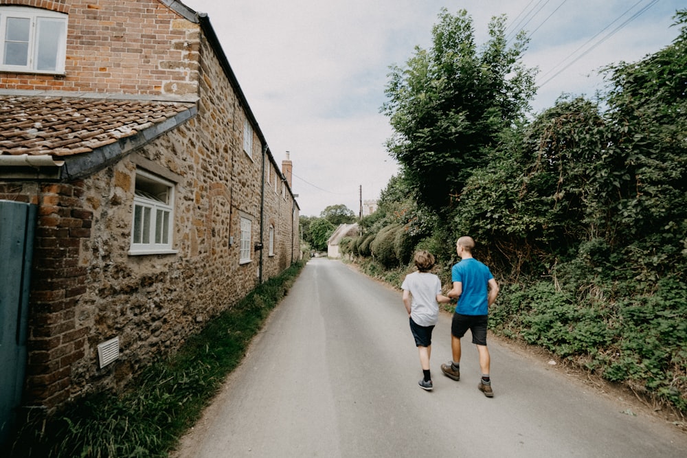 woman in blue t-shirt walking on pathway