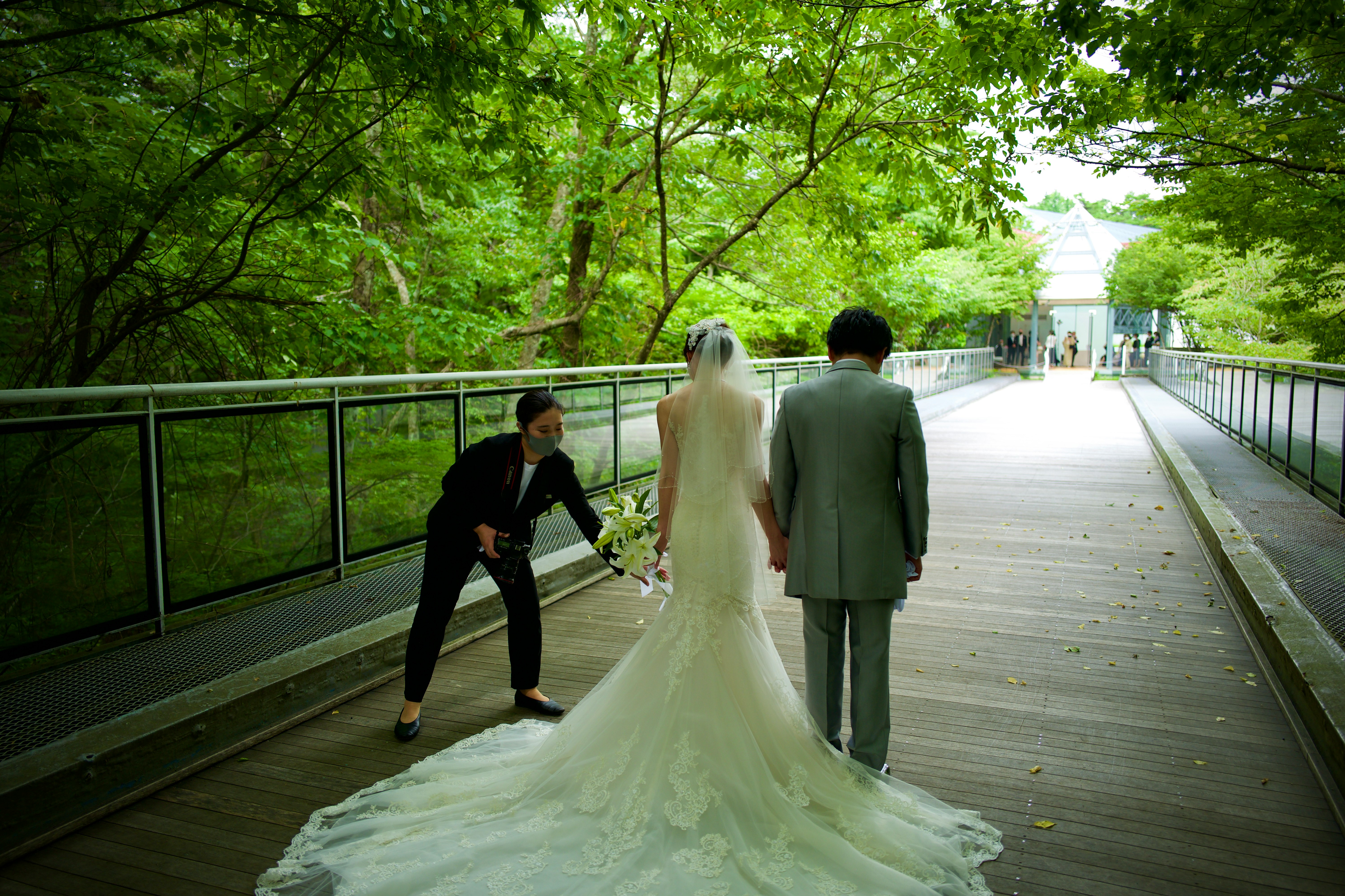 bride and groom walking on wooden bridge