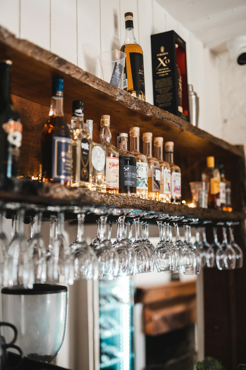 clear glass bottles on brown wooden shelf