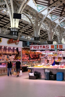 woman in black shirt standing in front of food display counter