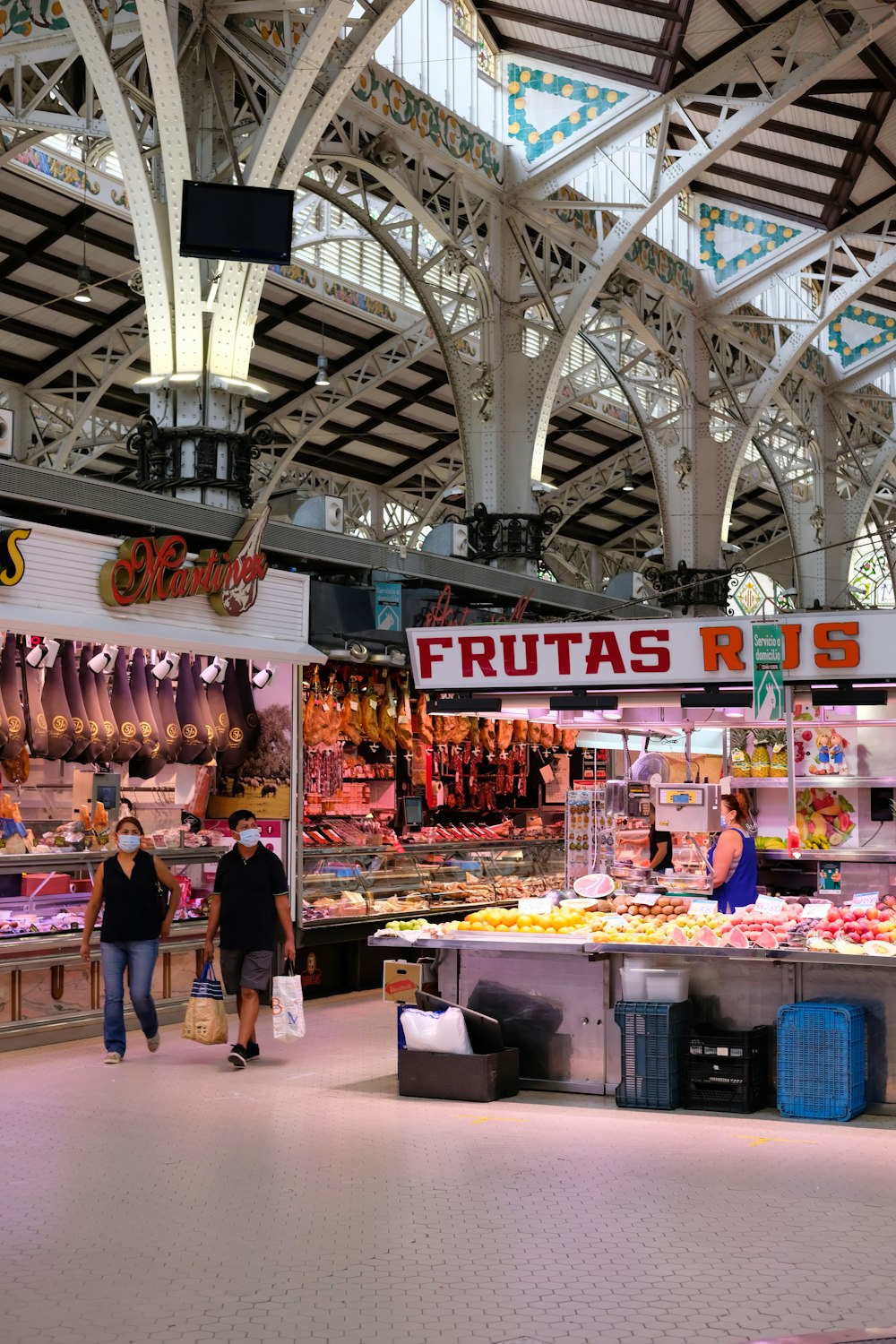 woman in black shirt standing in front of food display counter