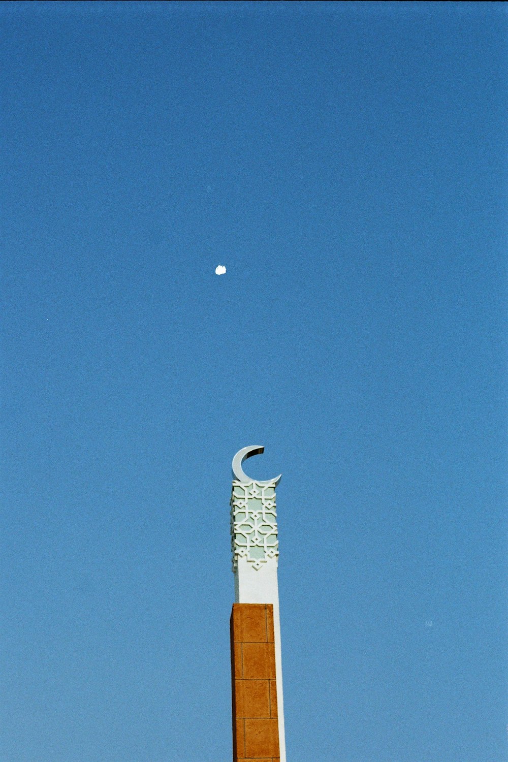 white and brown concrete tower under blue sky