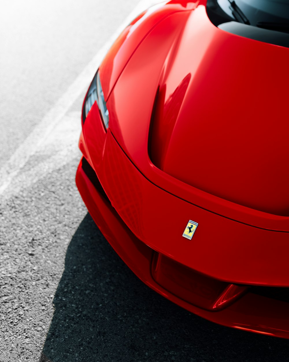 red ferrari car on road during daytime