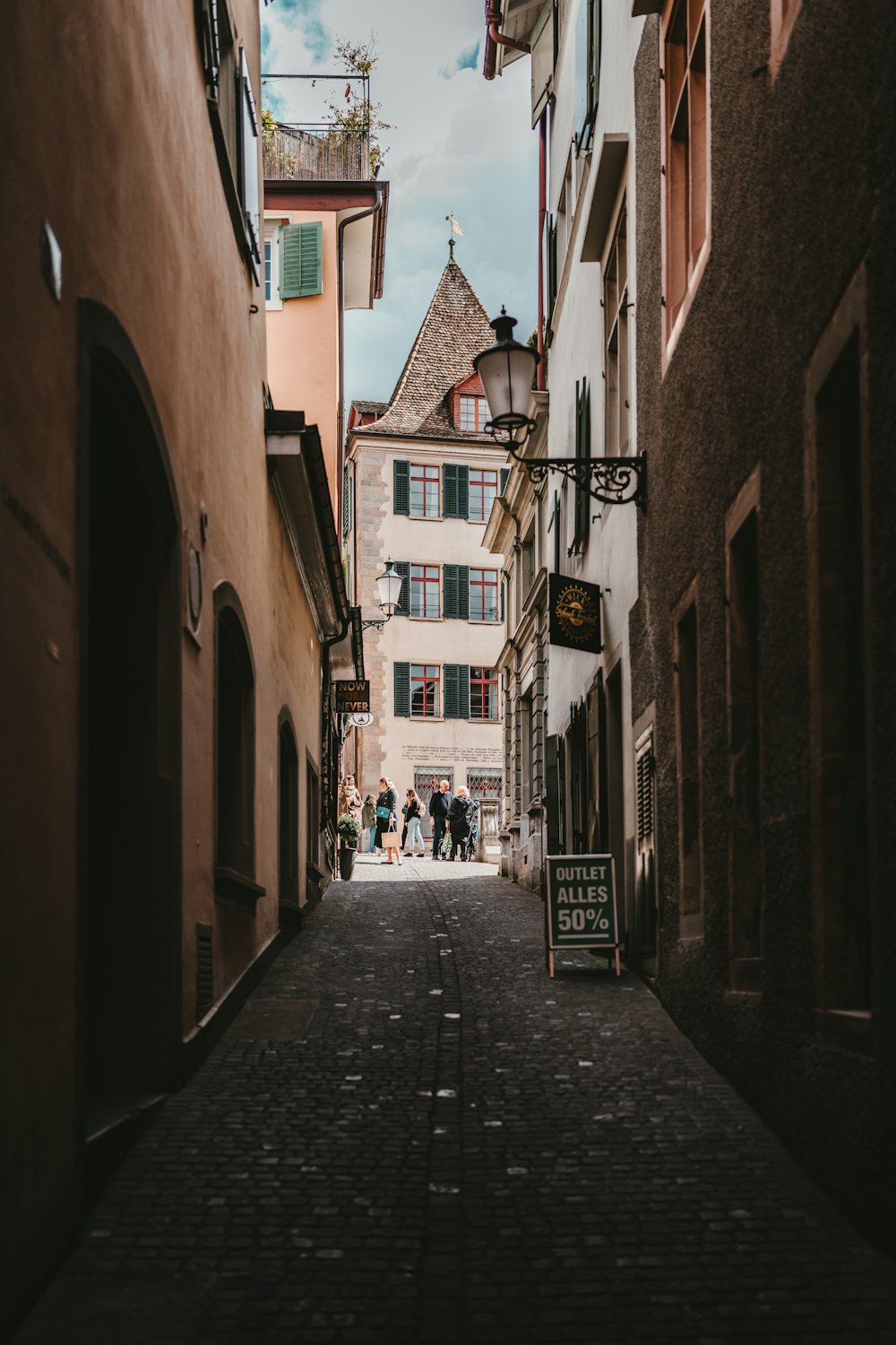 people walking on street between buildings during daytime