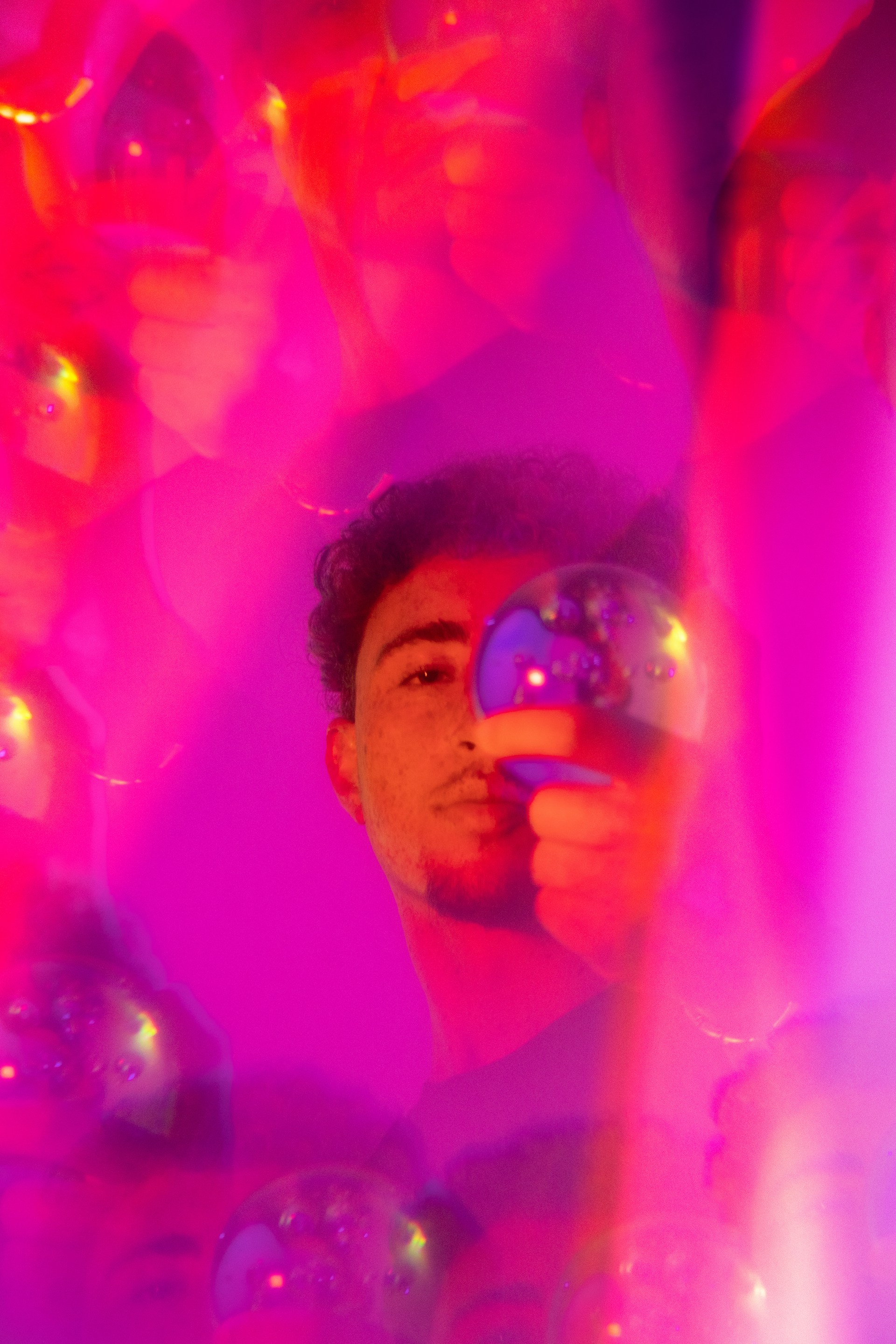 man in white shirt holding clear glass ball