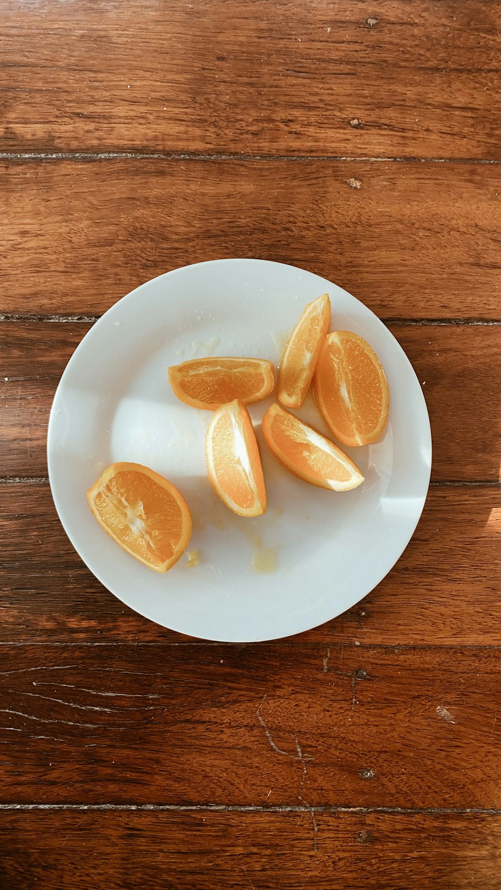 sliced orange fruit on white ceramic plate