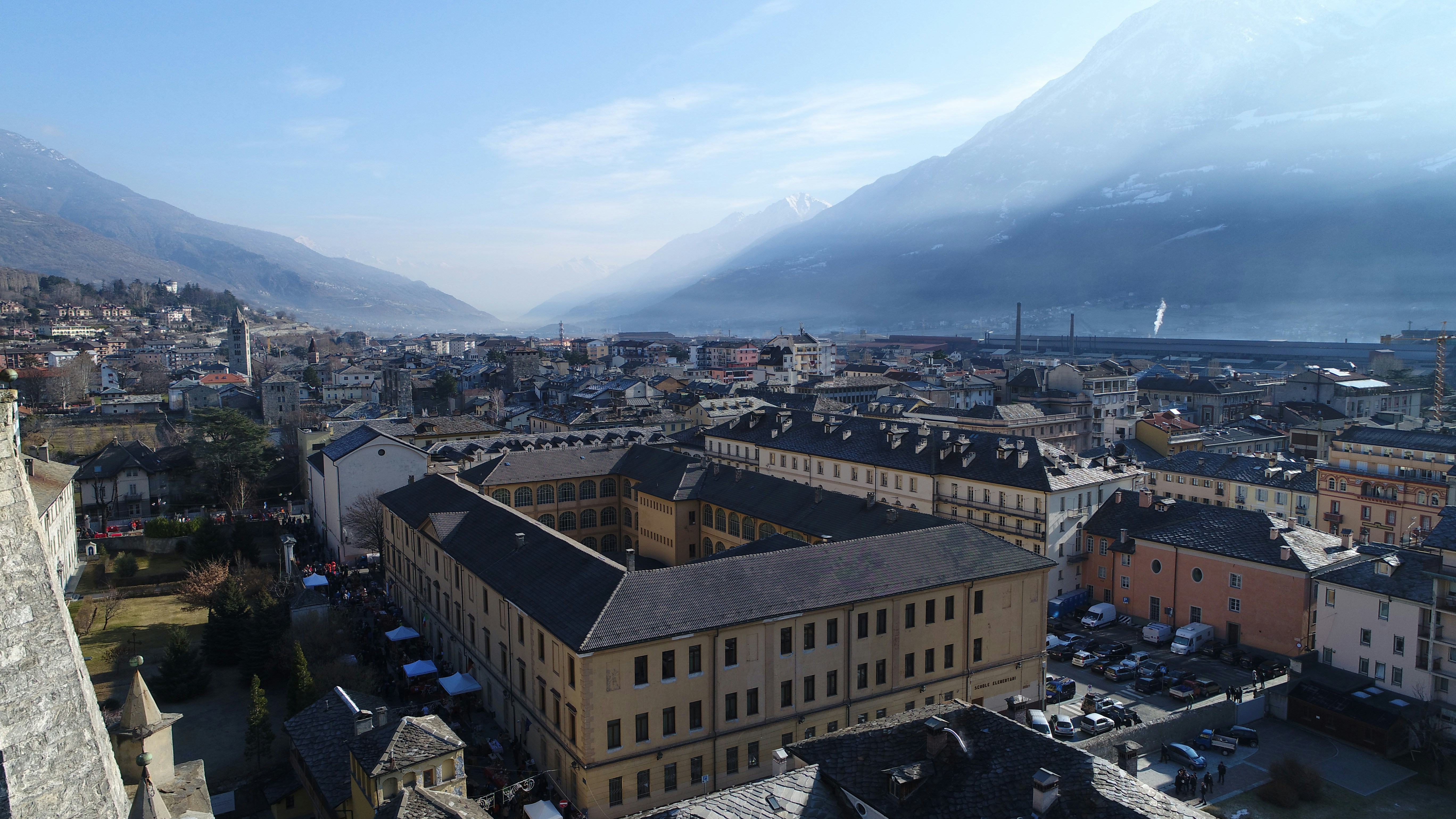 brown concrete building near mountain during daytime