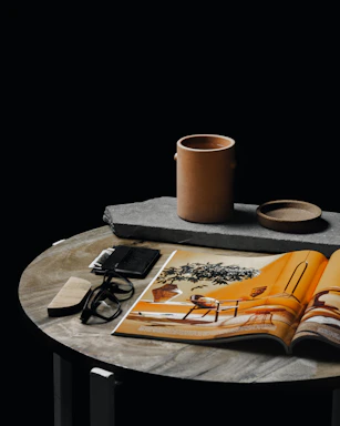 white ceramic mug on brown book