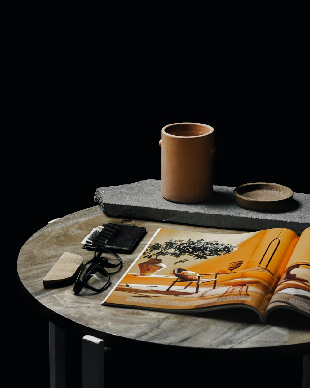 white ceramic mug on brown book