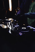 person in black jacket playing dj controller